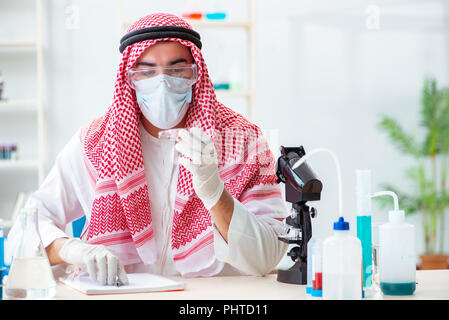 Arab doctor chemist studying new virus in lab Stock Photo