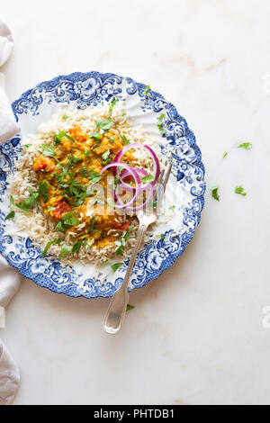 Indian vegan dinner - dal, rice and onion. Stock Photo