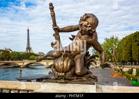 Statue of cupid with sea monster on the Alexander III Bridge with the Eiffel Tower in the background in Paris, France on 26 August 2018 Stock Photo