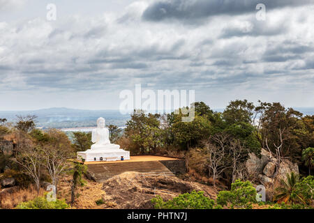 The great statue of the Buddha at the sacred mountain of Mihintale in Sri Lanka Stock Photo