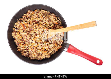 assorted cooked rice with vegetables in a frying pan on white isolated background Stock Photo
