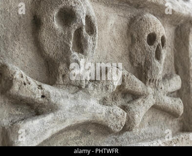 Ancient stone skull with crossbones Stock Photo