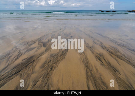 Black patterns on the beach sand Stock Photo