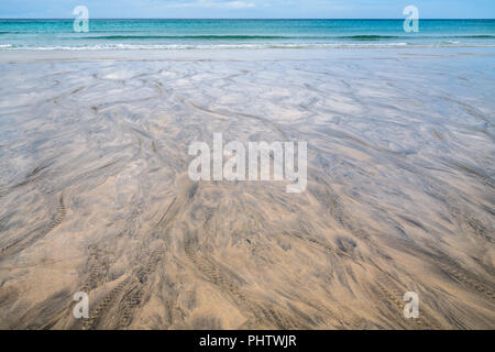 Black patterns on the beach sand Stock Photo