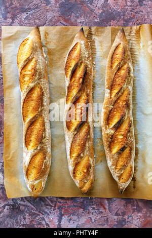 Freshly baked artisanal baguettes. Stock Photo