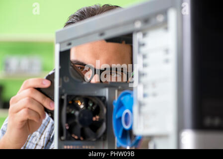 Computer engineer repairing broken desktop Stock Photo