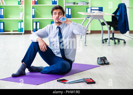 Employee doing exercises during break at work Stock Photo