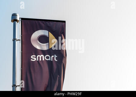 BELGRADE, SERBIA - SEPTEMBER 1, 2018: Logo of Smart on a flag in front of its dealership for Belgrade. Part of Daimler Benz Group, Smart is a brand of Stock Photo