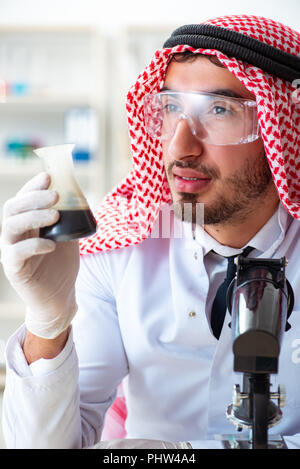 The arab chemist working in the lab office Stock Photo - Alamy
