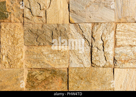 Stone wall as a background or texture. An example of masonry as a cladding of external walls. Stock Photo