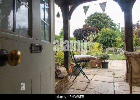 Looking out into a country garden from a inside a Victorian cottage Stock Photo