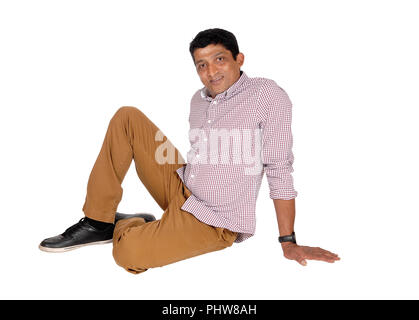 Relaxed East Indian man sitting on floor Stock Photo