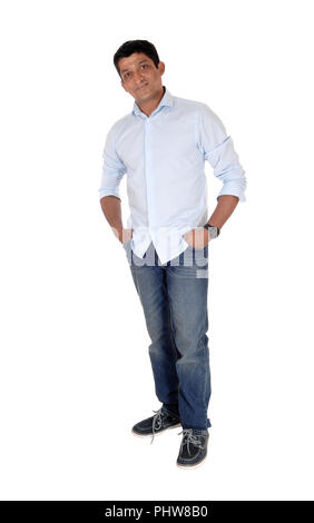 Relaxed Indian man standing in jeans and sneakers Stock Photo