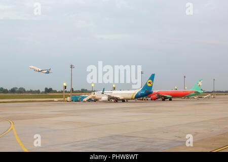 KIEV, UKRAINE - August 22, 2016: In the parking lot at Zhulyany airport Boeing 737-800(UR-PSA) and Airbus A321-211 (UR-WRO) airlines 'Ukraine Internat Stock Photo