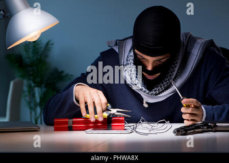 Terrorist bomber preparing dynamite bomb Stock Photo