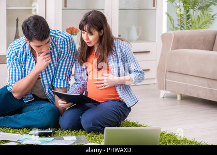 Young family in budget planning concept Stock Photo