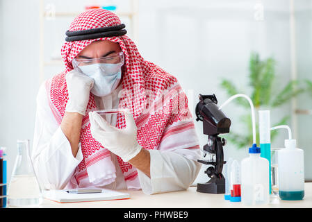 Arab doctor chemist studying new virus in lab Stock Photo