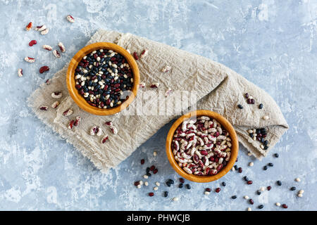 Different types of beans in wooden bowls. Stock Photo