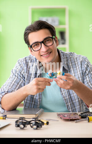 Computer engineer repairing broken desktop Stock Photo