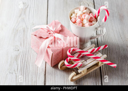 Christmas cup with small marshmallows and candy canes Stock Photo