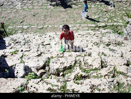 A young boy climbs the steps leading up to the 3rd enclosure of Nakagusuku Castle ruins in Kitanakagusuku Village, Okinawa Prefecture, Japan, on May 2 Stock Photo