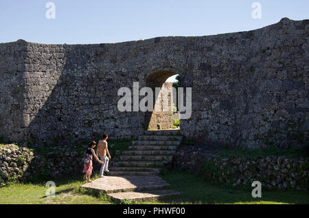 Visitors stroll around the Nakagusuku Castle ruins in Kitanakagusuku Village, Okinawa Prefecture, Japan, on May 20, 2012. Nakagusuku Castle, which dat Stock Photo