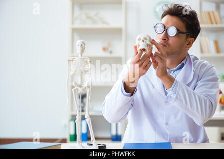 Crazy doctor studying human skeleton Stock Photo