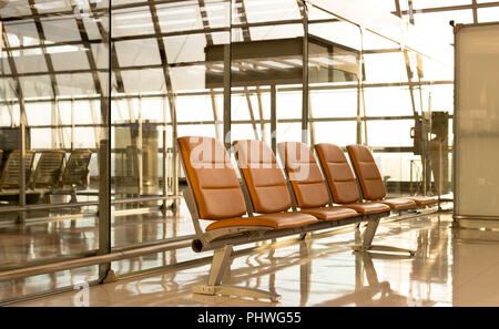 Orange color chair in airport waiting room Stock Photo