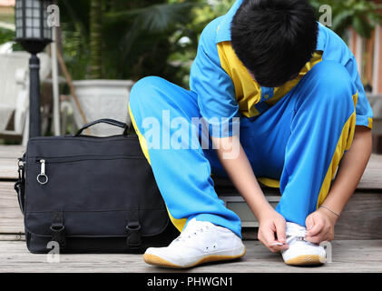 Unidentified boy tying Laces ready for school Stock Photo
