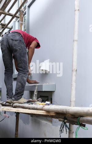Unidentified builder making construction for ventilation Stock Photo