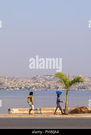 Angolan women walking along the seashore, Benguela Province, Lobito, Angola Stock Photo