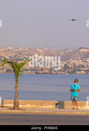 European tourist controling his Mavic drone, Benguela Province, Lobito, Angola Stock Photo
