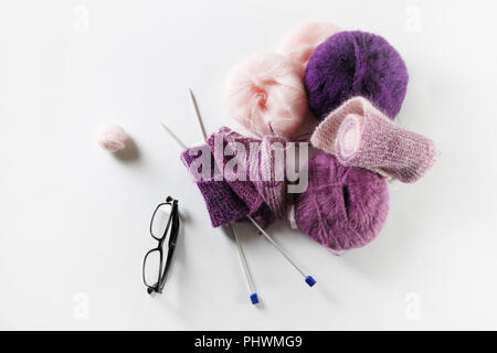 Yarn for knitting. Wool, glasses and knitting needles. Flat lay Stock Photo