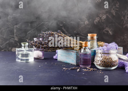 Essential lavender oil and dry lavender flowers. Stock Photo