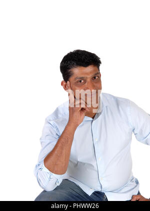 Handsome man thinking with hand on face Stock Photo
