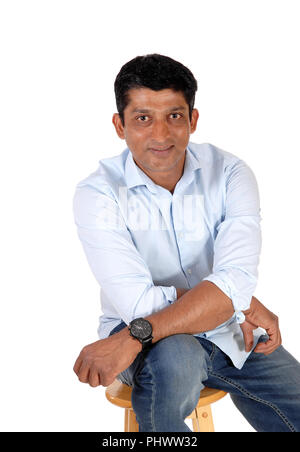 Relaxing middle age man sitting on chair Stock Photo