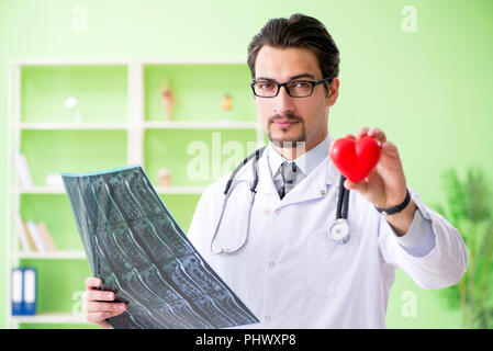 Doctor radiologist looking at x-ray scan in hospital Stock Photo