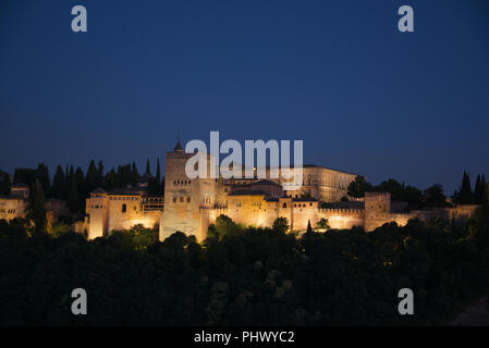 The Alhambra with the Torres de Comares and Nasrid Palaces lit at night Granada Andalucia Spain Stock Photo