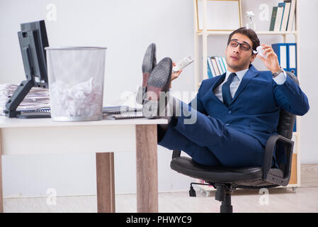 Young handsome businessman employee working in office in paperwo Stock Photo