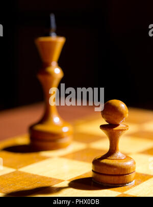 Chess pieces on playing board Stock Photo