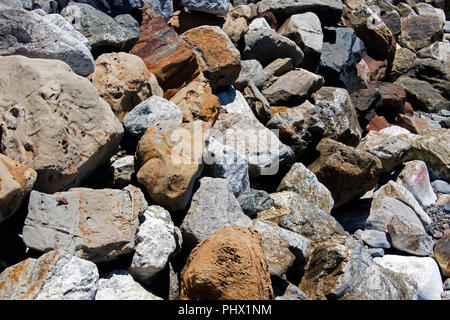A view of rocks and stones at the Malibu beach from an high angle view for backgrounds or wallpapers in summer time Stock Photo