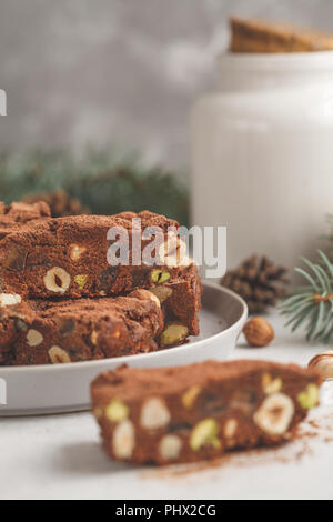 Italian Christmas dessert panforte with nuts, chocolate and candied fruits. Christmas background, Christmas dessert concept. Stock Photo