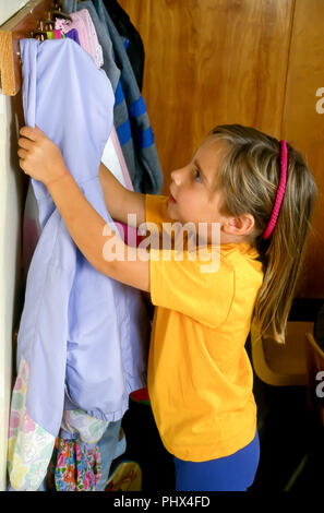 https://l450v.alamy.com/450v/phx4fd/school-girl-hanging-up-jacket-in-classroom-mr-myrleen-pearson-ferguson-cate-phx4fd.jpg