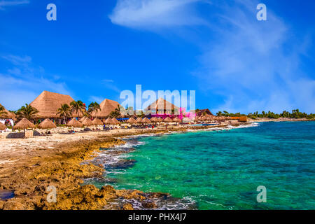 Colorful huts on a rocky beach in Mexico Stock Photo