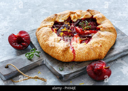 Homemade pies (Galette) with yellow and red plums. Stock Photo