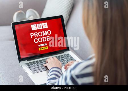 Close up back woman shopping online with promo code on laptop add to cart function webpage at sofa in home,Digital marketing concept.digital lifestyle Stock Photo