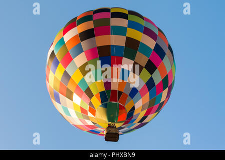 A colorful hot air balloon against a blue sky. Stock Photo