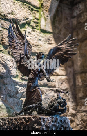 angel fighting demon statue