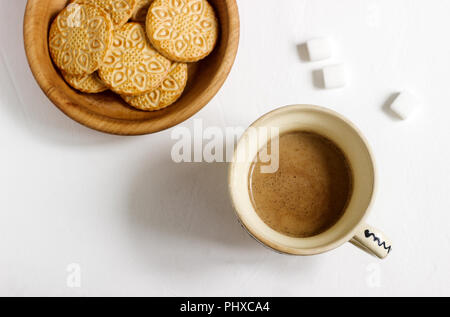 Coffee with milk in an old cup, served with biscuits and sugar on a light background. Selective focus. Stock Photo