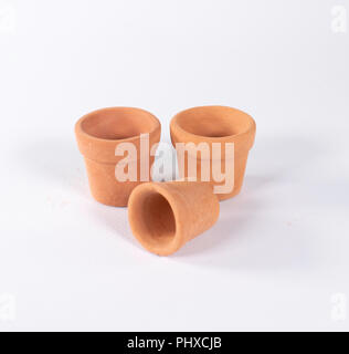 Set of three empty terracotta pots isolated on white. Stock Photo